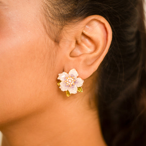 Add a touch of whimsy to your wardrobe with our Amethyst Flora Statement Earring. This playful piece features beautiful amethyst stones that will add a pop of color to any outfit. Stand out from the crowd and let your unique style shine with this quirky accessory.  Material: Stainless Steel Plating: 18K Gold-Plated Waterproof Hypoallergenic Anti-tarnish
