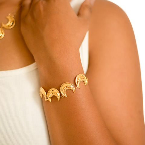 Add a touch of celestial elegance with the Moonlit Grace Bracelet. Featuring a delicate design inspired by the moon, this bracelet will bring a sense of grace and beauty to any outfit. Shine bright like the moon with this unique accessory. Perfect for any occasion.&nbsp;  Material: Stainless Steel Plating: 18K Gold-Plated Waterproof Hypoallergenic Anti-tarnish
